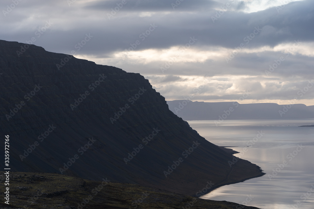 Fototapeta premium Fjord illuminated by sunset in Westfjords Iceland