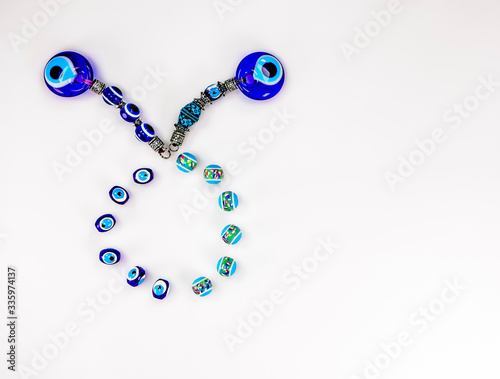 Pretty Turkish evil eye pendants isolated against a white background photo