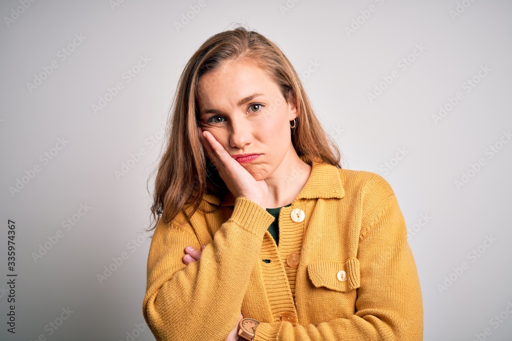 Young beautiful blonde woman wearing casual sweater over isolated white background thinking looking tired and bored with depression problems with crossed arms. Young beautiful blonde woman wearing casual sweater over isolated white background thinking looking tired and bored with depression problems with crossed arms.
