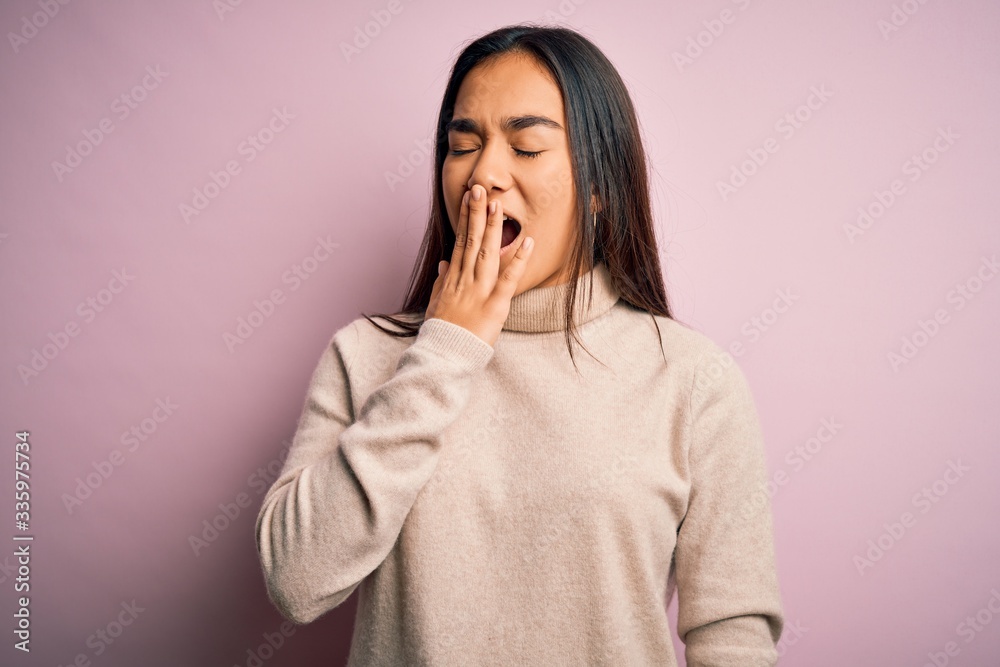 Young beautiful asian woman wearing casual turtleneck sweater over pink background bored yawning tired covering mouth with hand. Restless and sleepiness. Young beautiful asian woman wearing casual turtleneck sweater over pink background bored yawning tired covering mouth with hand. Restless and sleepiness.