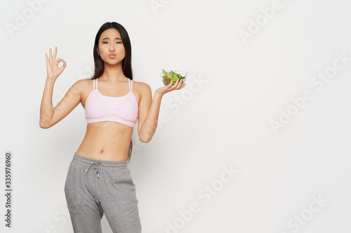 young woman holding a salad © SHOTPRIME STUDIO