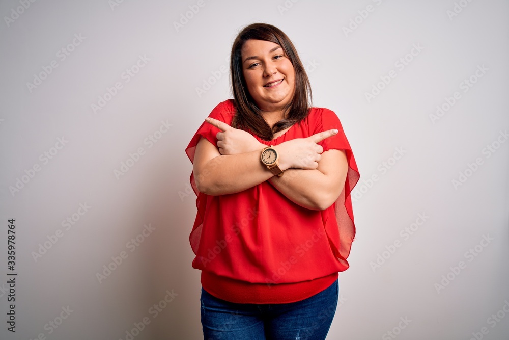 Beautiful brunette plus size woman wearing casual red t-shirt over isolated white background Pointing to both sides with fingers, different direction disagree Beautiful brunette plus size woman wearing casual red t-shirt over isolated white background Pointing to both sides with fingers, different direction disagree