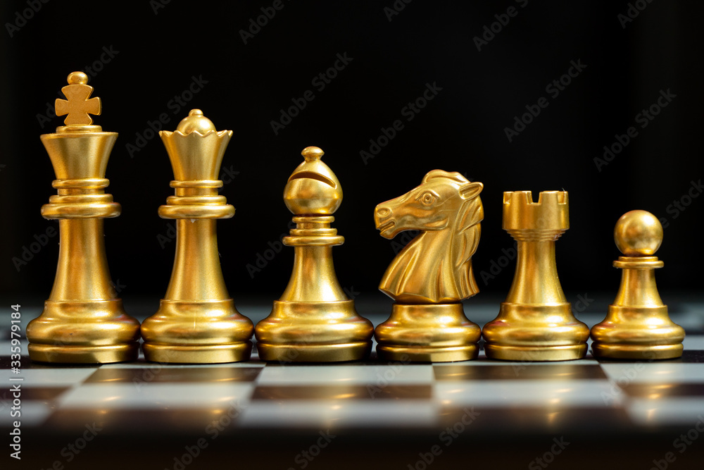 Gold chess piece stand in a row (king, queen, bishop, knight, rook, pawn) on black background Gold chess piece stand in a row (king, queen, bishop, knight, rook, pawn) on black background