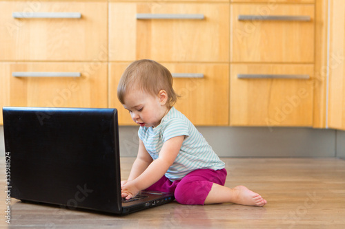 small child plays on computer. The child Prodigy learns the techniques of business Planning, home work, quarantine, self-isolation, protection from coronavirus, virus, home education, distance work.