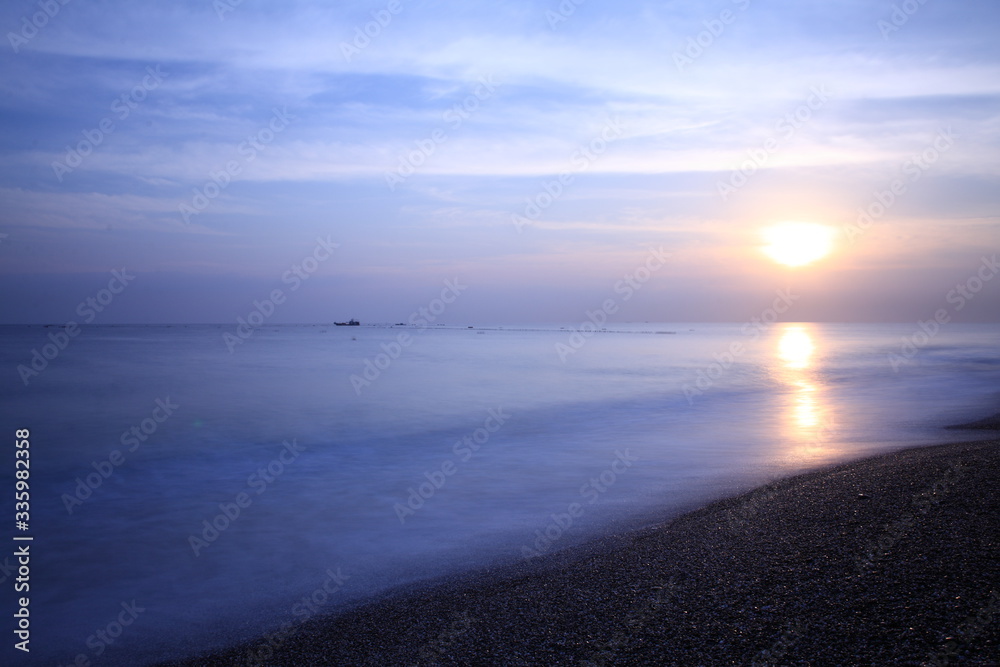 Long exposure sunrise seascape with Chinese fishing junks in the background Long exposure sunrise seascape with Chinese fishing junks in the background