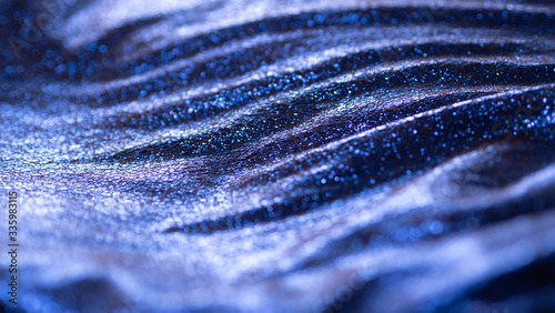 Sea wave like metallic and electric blue fabric with shiny reflective cracked surface