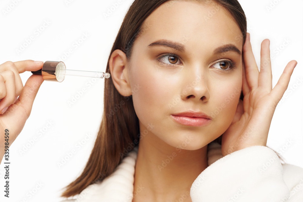 young woman applying mascara young woman applying mascara