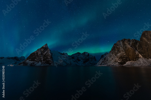 Aurora borealis or North light over Olstind mountain in Hamnoy village, Lofoten island in Norway, Scandinavia © skazzjy