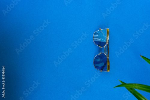 Sunglasses on blue background. Summer background