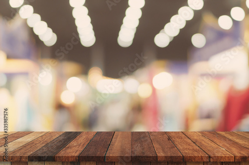 Abstract blurred image of department store with wooden table counter background for show   promote  design on display concept