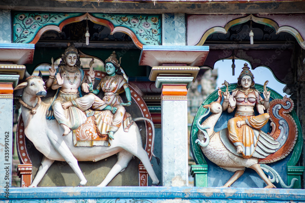 Obraz premium Hindu temple in Tamil Nadu, South India. Sculptures on Hindu temple gopura (tower), sculpture of an Indian deity