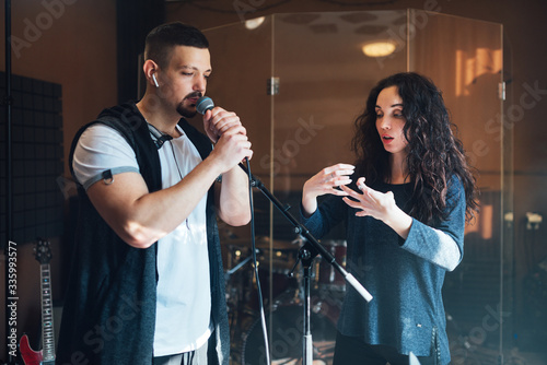 Bild auf Leinwand Musical teacher coaching a young male vocalist