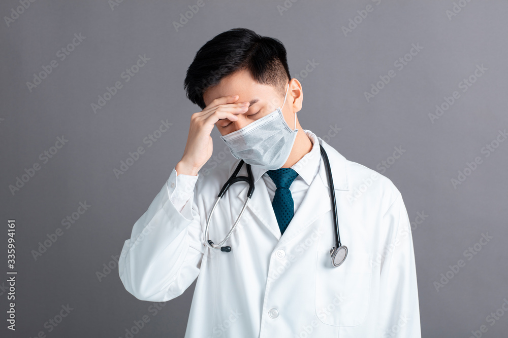 stress and tired young Doctor Wear Medical Mask