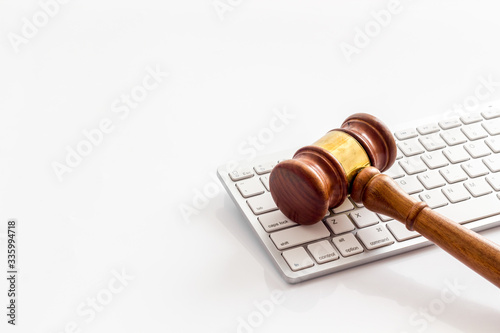 Judge gavel near keyboard - desk of contemporary lawyer - on white background copy space