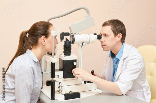 Eye doctor exam patient pressure heath. ophthalmology concept. astigmatism diagnosis at clinic. Eyecare consultation service. ophthalmologist looking cataract. Hospital equipment