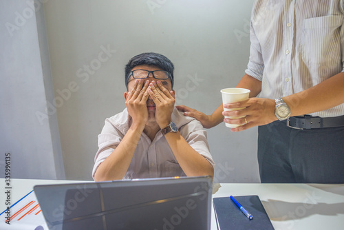 The man feeling tired and frustrated at workplace photo