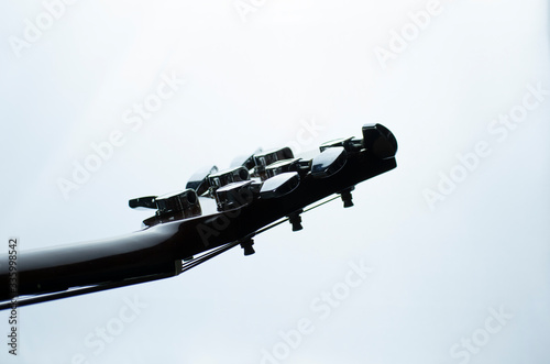 Macro elements of an acoustic guitar on a light background in monochrome.