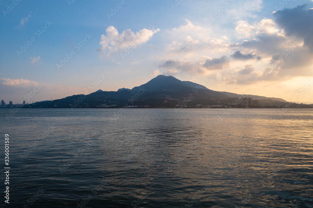 sunset over the sea with mountain background,