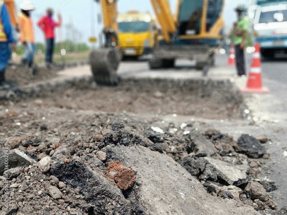 Blurred images, excavation of roads repaired using heavy machinery and human labor Blurred images, excavation of roads repaired using heavy machinery and human labor