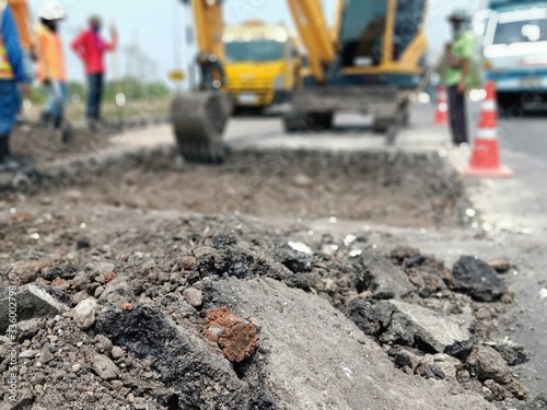 Blurred images, excavation of roads repaired using heavy machinery and human labor
