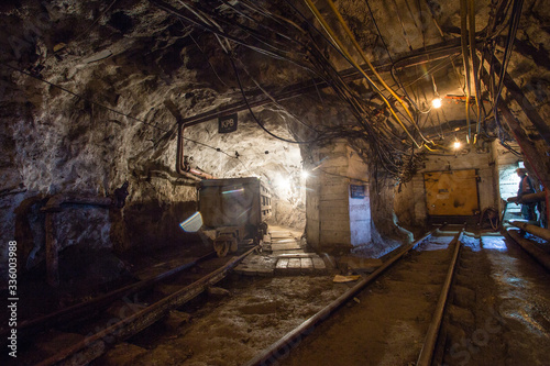 Underground gold mine tunnel with rails and wagon