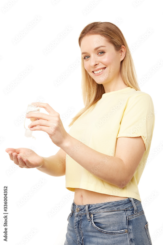Beautiful woman holding a bottle of hand sanitizer Beautiful woman holding a bottle of hand sanitizer