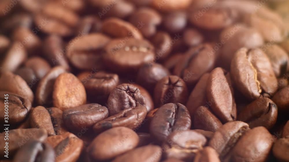 The texture of the roasted coffee beans on a swivel background. The texture of the roasted coffee beans on a swivel background.