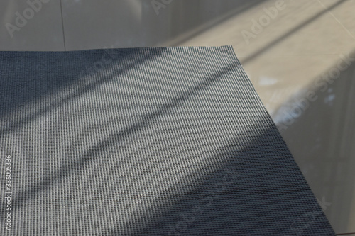 yoga mat put on floor in side fitness gym, image sport exercise background with sunlight in the morning day © sutichak