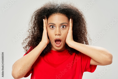 portrait of a young woman covering her ears