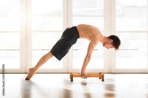 Fit young man doing a calisthenics planche pose