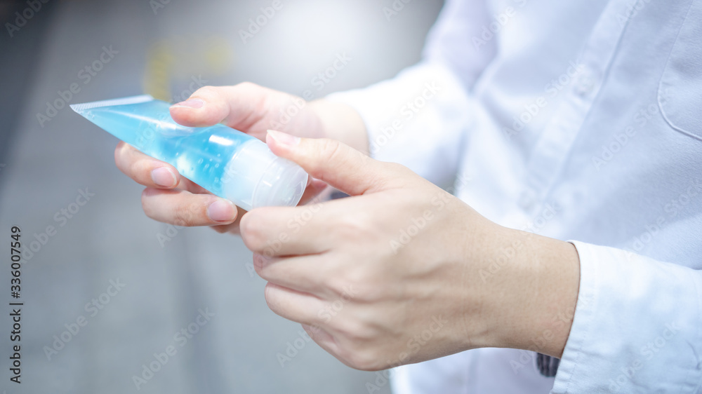 Male hand using hand skin sanitizer gel tube for washing hand. Health awareness for pandemic protection. Health care concept