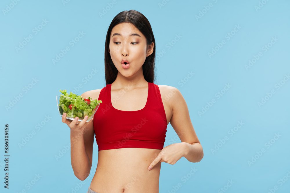 young woman holding a bowl of salad young woman holding a bowl of salad
