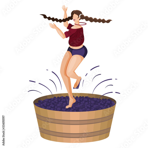 Village young woman is crushing grapes with her feet while dancing in large wooden vat