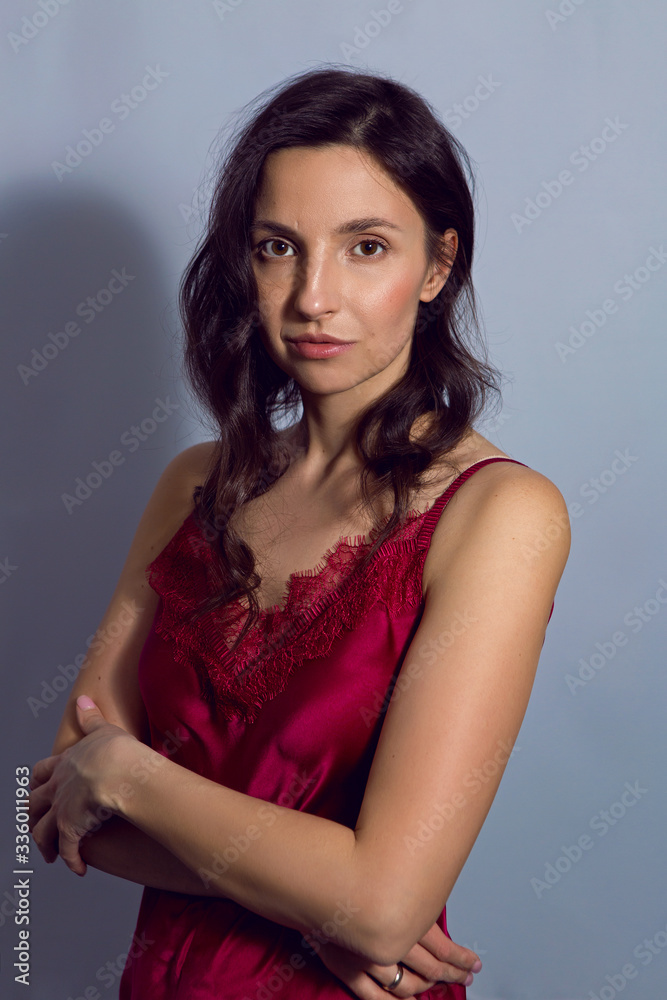 portrait of a brunette girl on a blue background portrait of a brunette girl on a blue background