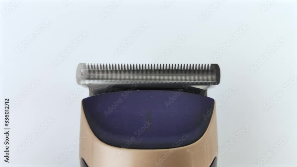 Macro video of a working hair clipper. A close-up shows how the blades move. Macro video of a working hair clipper. A close-up shows how the blades move.