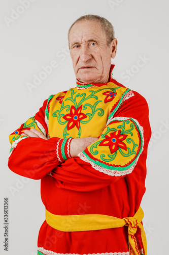 An elderly man in Slavic clothing on a white background