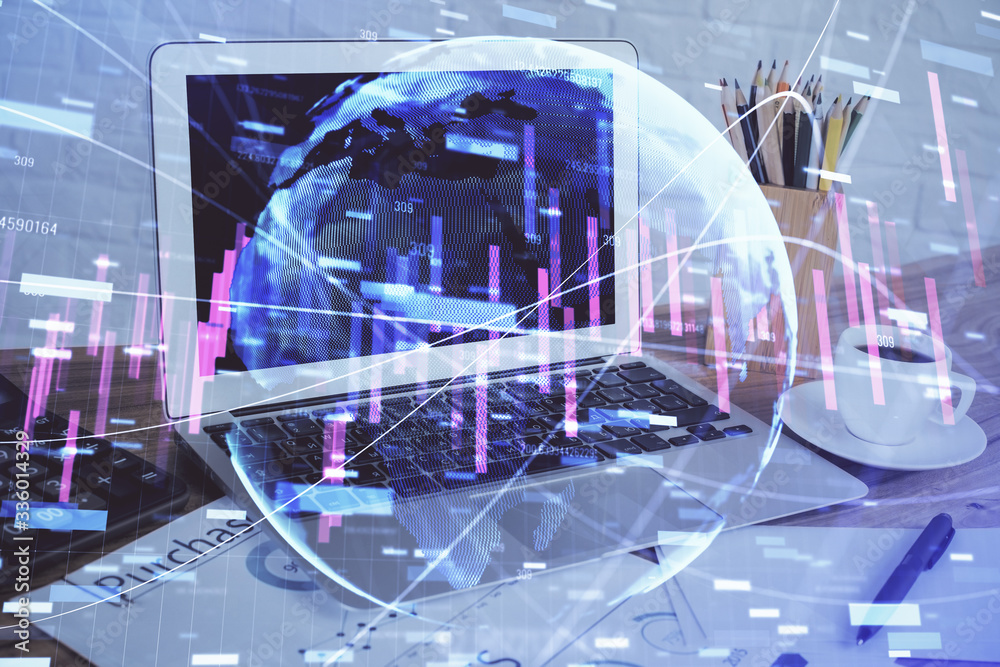 Financial graph colorful drawing and table with computer on background. Double exposure. Concept of international markets. Financial graph colorful drawing and table with computer on background. Double exposure. Concept of international markets.