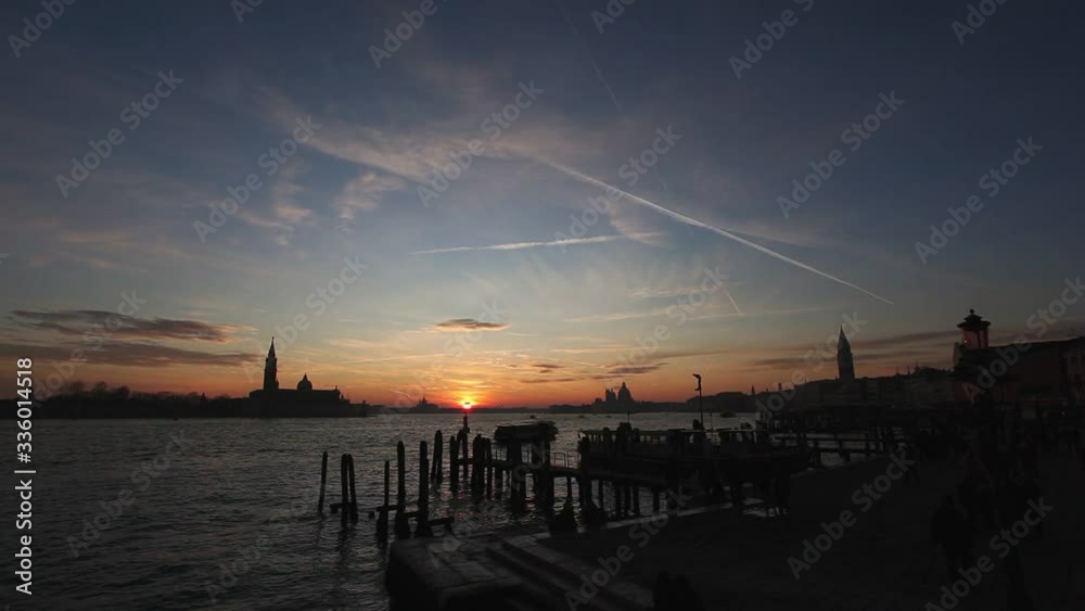 Wonderful sunset over the San Marco Basin seen from the pier, Venice, Italy. Concept: sunset over Venice, tranquility and spirituality, travel to famous places Wonderful sunset over the San Marco Basin seen from the pier, Venice, Italy. Concept: sunset over Venice, tranquility and spirituality, travel to famous places