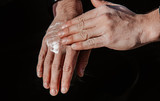 A man creams his hands after using a lot of disinfectant