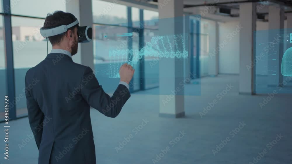 Augmented Reality. Close-up of a Male Patient Checking his Health: Medical Charts, 3D Hologram (DNA hologram, Pulmonary System, Muscular System, COVID-19) Wearing VR Glasses and Headsets. Future Augmented Reality. Close-up of a Male Patient Checking his Health: Medical Charts, 3D Hologram (DNA hologram, Pulmonary System, Muscular System, COVID-19) Wearing VR Glasses and Headsets. Future