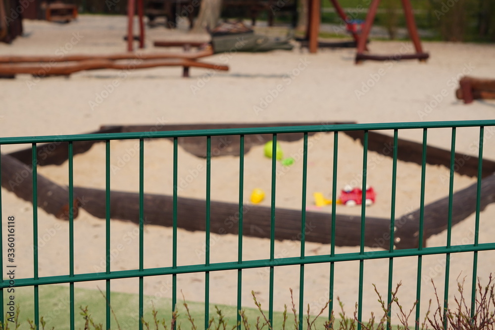 Fototapeta premium Children's playground is closed. Ban on children 's playgrounds. Prevention of coronavirus COVID-19. The fight against the virus. No children on the Playground in the yard.