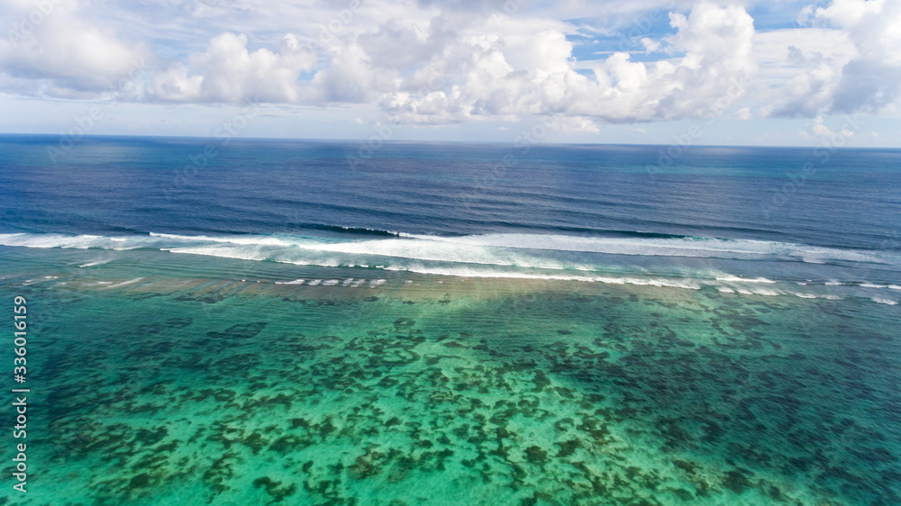 Obraz premium Tropical beach and sea with blue sky background. Aerial view.