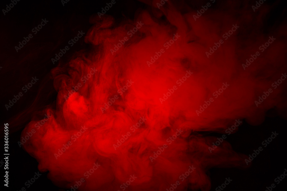 Colorful smoke close-up on a black background. Red cloud of smoke.