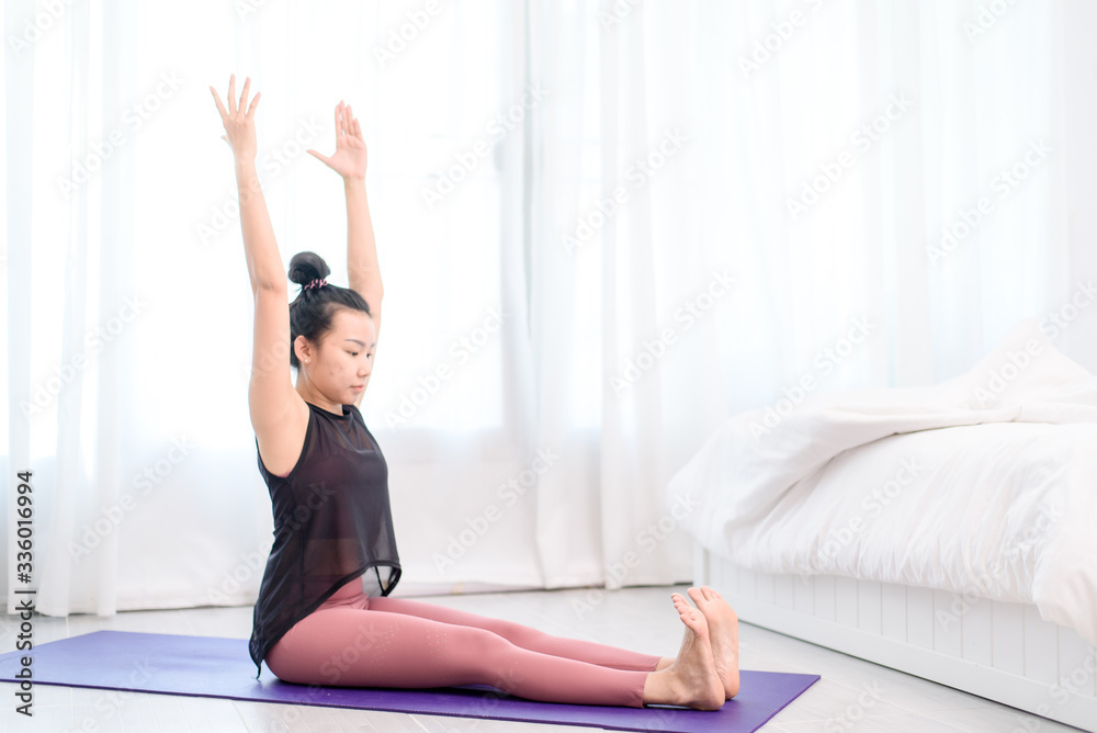 Young woman do yoga in a bed room Young woman do yoga in a bed room