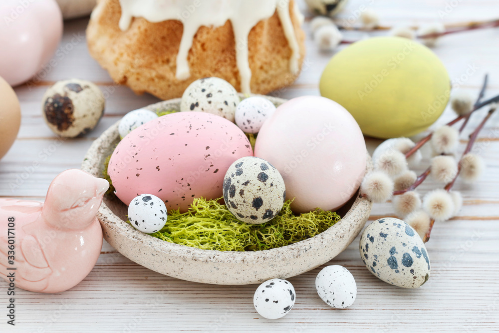 Easter table with cakes, eggs and catkins.