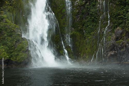 Waterfall in Milford Sound in Fiordland National Park in Southland on South Island of New Zealand 