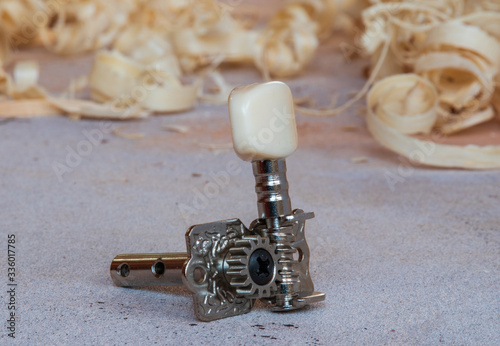 single tuning peg for classical guitar on the workbench photo