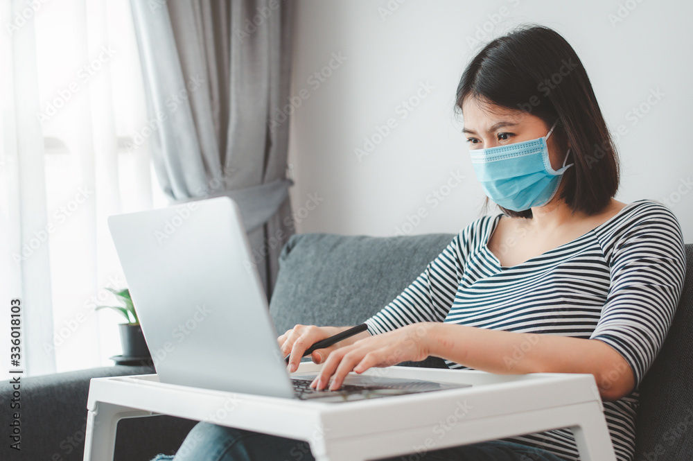 woman wearing face mask working from home woman wearing face mask working from home