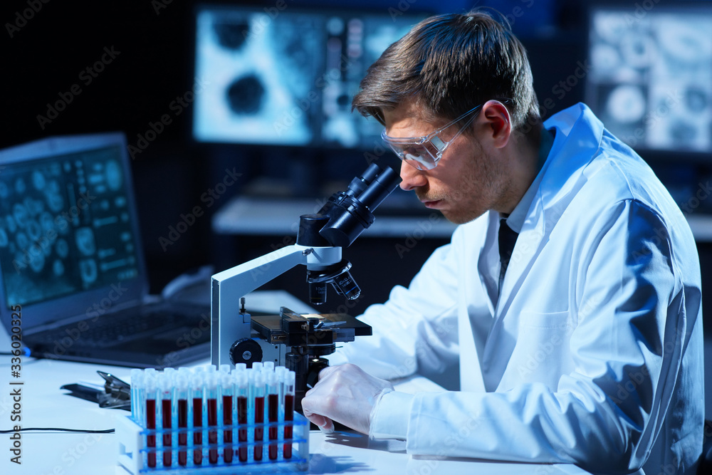 Scientist working in lab. Doctor making microbiology research. Laboratory tools: microscope, test tubes, equipment. Coronavirus covid-19 , bacteriology, virology and health care. Scientist working in lab. Doctor making microbiology research. Laboratory tools: microscope, test tubes, equipment. Coronavirus covid-19 , bacteriology, virology and health care.