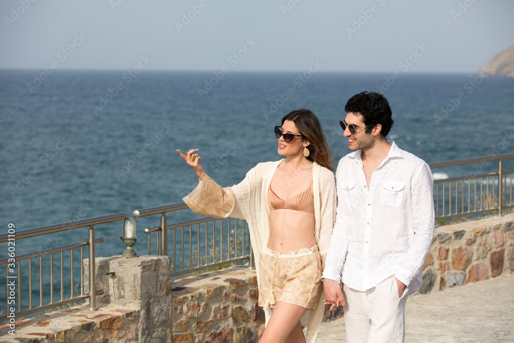 Happy couple enjoying in summer sun on the beach